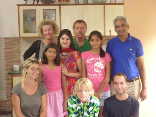 a group of people posing for a picture in a kitchen at The Coral Tree Boutique Homestay in Agra