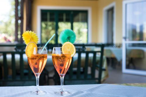 two wine glasses with fruit on top of a table at Vitalhotel Marienhof in Velden am Wörthersee