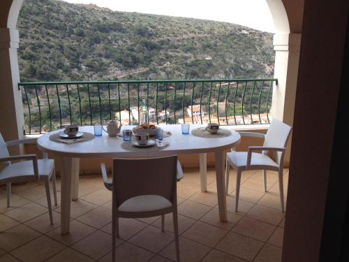 a table and chairs in a room with a view at Buggerru a Mare Residence in Buggerru