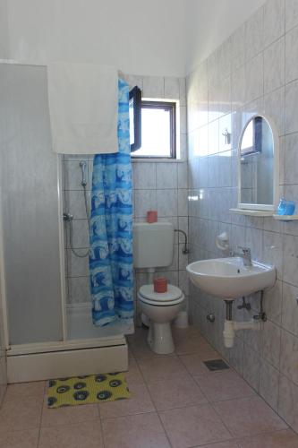 a bathroom with a toilet and a sink at Apartmani Vesna Supetar in Supetar