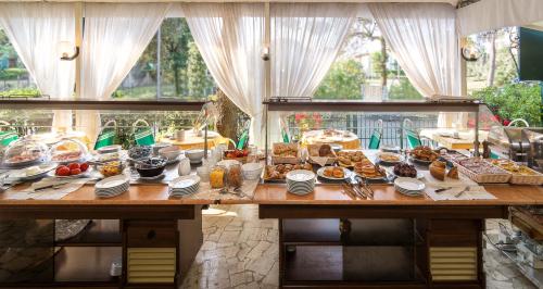 a table with a bunch of food on it at Hotel Verdemare in Marina di Pietrasanta