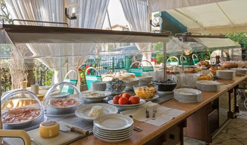 a buffet line with food on a table at Hotel Verdemare in Marina di Pietrasanta