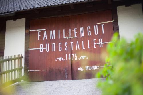 a wooden garage door with a sign on it at Familiengut Hotel Burgstaller in Döbriach