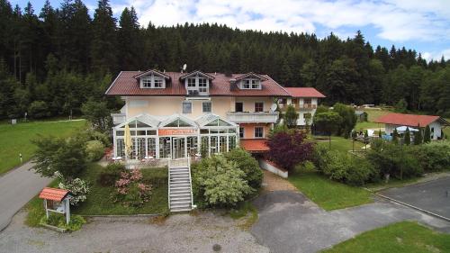 an aerial view of a large house with a garden at Landgasthof zum Hirschenstein, Pension Garni in Sankt Englmar