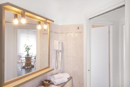 a bathroom with a large mirror and a table at Residence Domaso in Domaso