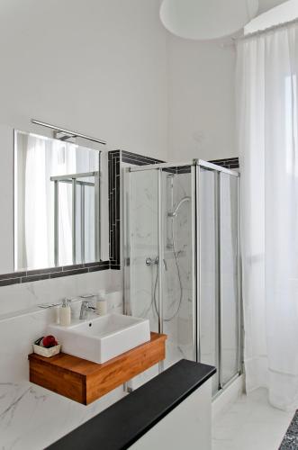 a white bathroom with a sink and a shower at Affittacamere "Angel 2" in La Spezia