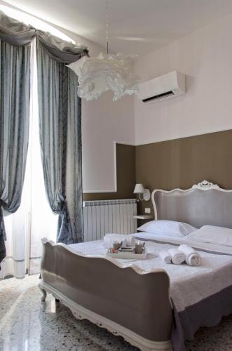 a bedroom with a large bed with towels on it at Affittacamere "Angel 2" in La Spezia