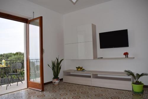 a living room with a tv on a wall at Sorrento Dolce Casa in Sorrento