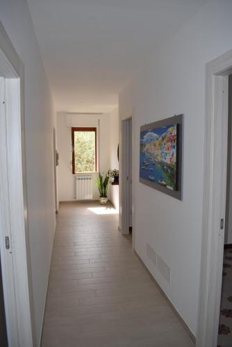 a hallway with white walls and a painting on the wall at Sorrento Dolce Casa in Sorrento