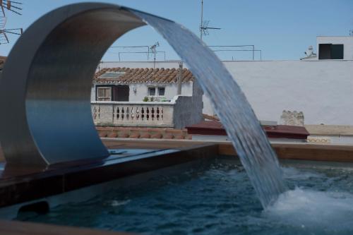 a water fountain in front of a building at Sindic Hotel - Adults Only in Mahón