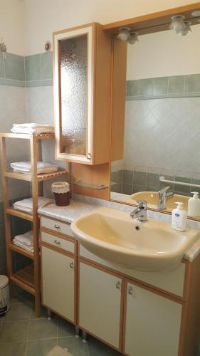 a bathroom with a sink and a mirror at Villa Malu in Anzio