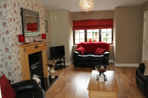 a living room with two couches and a fireplace at Garden View Self Catering Lough Rynn in Mohill