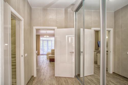 a room with a glass door with a living room at Fortuna in Svetlogorsk