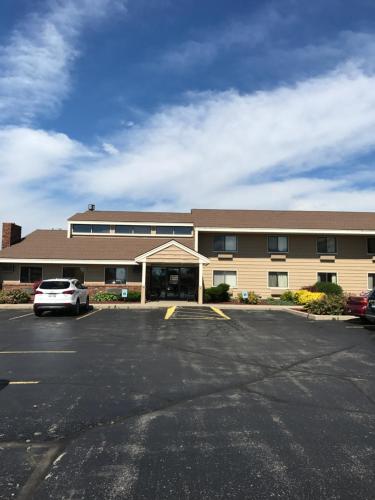 a parking lot in front of a building at AmericInn by Wyndham West Bend in West Bend