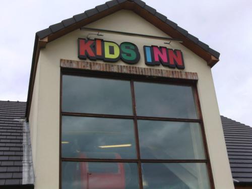 a kids inn sign on top of a building at The Wishing Well in Selby