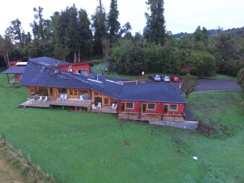 an aerial view of a house with a large yard at Lodge El Taique in Puyehue