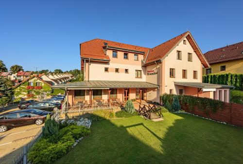 a large house with a lawn in front of it at Penzion Krumlov - Massage studio in Český Krumlov