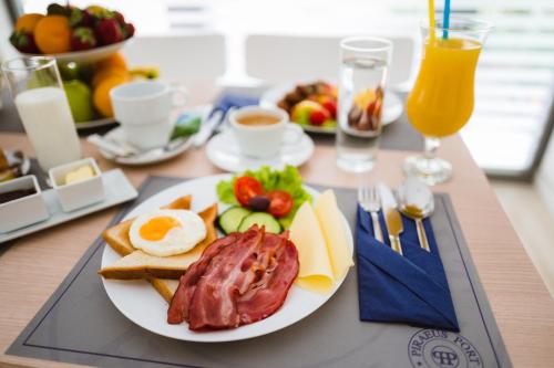 a plate of breakfast food on a table at Piraeus Port Hotel in Piraeus