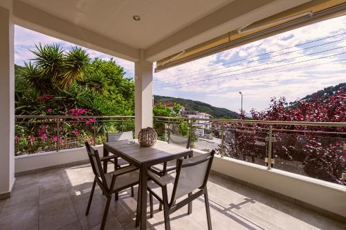 a table and chairs on a balcony with a view at Rousis Studios in Parga