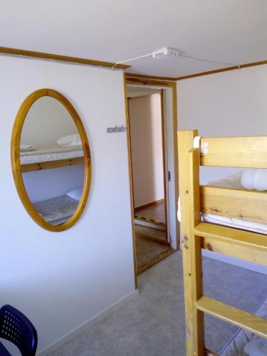 a room with a mirror and a bunk bed at Kungshamns Vandrarhem in Kungshamn
