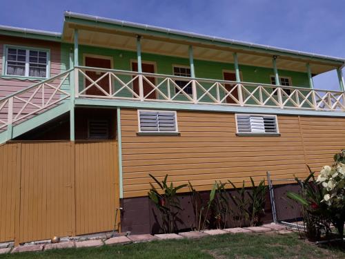 a house with a balcony on top of it at Apartment Unforgetable Gardens in Falmouth