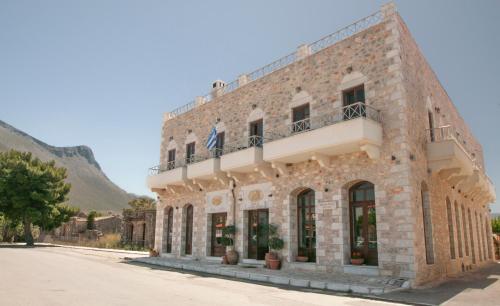 a large brick building on the side of a street at Areos Polis Boutique Hotel in Areopoli