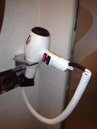 a hair dryer is attached to a wall at Hotel & Spa Princesa Munia in Oviedo