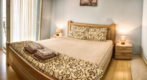 a bedroom with a large bed with two candles on it at Apartments Kula in Risan