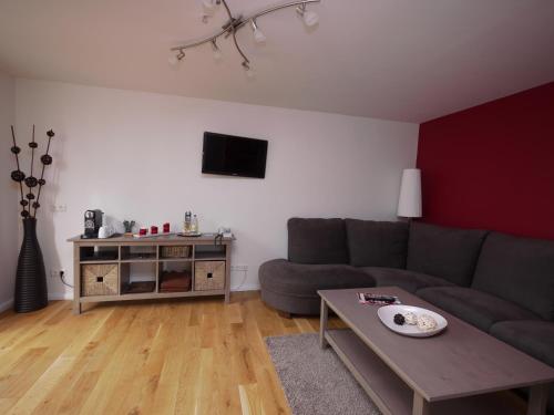 a living room with a couch and a table at Gasthof Oldenwöhrden in Wöhrden