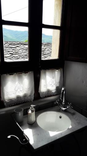a bathroom with a sink and a window with a view at Ca' d'Alfieri in Bardi
