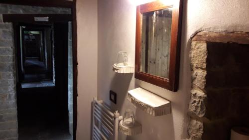 a bathroom with two sinks and a mirror on the wall at Ca' d'Alfieri in Bardi