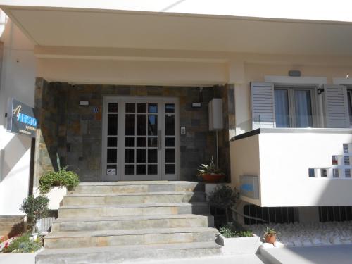 a house with stairs leading to a door at Aristo Apts in Hersonissos
