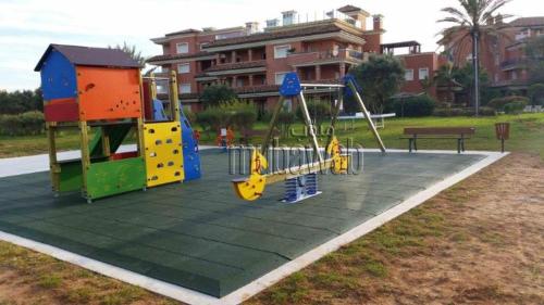 a park with a playground with a swing at Bouznika Charly's in Bouznika