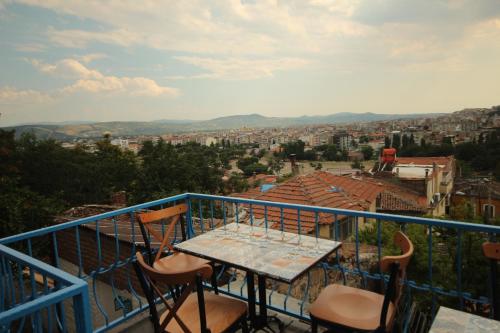 a table and chairs on a balcony with a view at TAŞKONAK in Bergama
