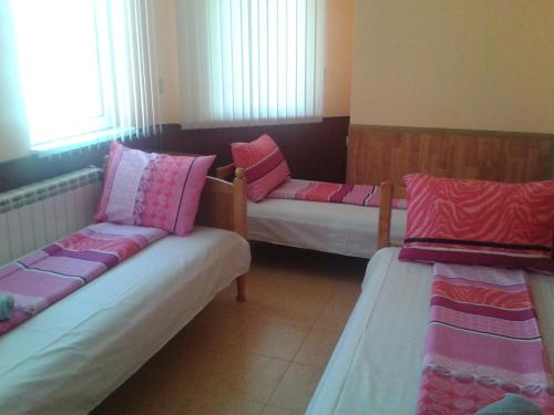 A bed or beds in a room at Osogovo Rooms