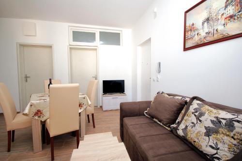 a living room with a couch and a table at Apartments Centar Sutomore in Sutomore