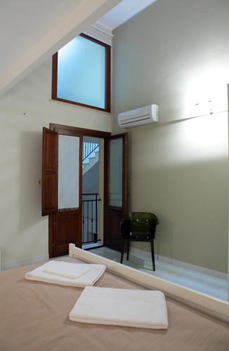 a room with a bed with two white towels at Palazzo Ossuna in Trapani