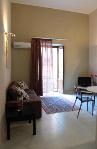 a living room with a couch and a table at Palazzo Ossuna in Trapani