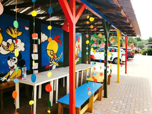 a play area with a wall with chickens on it at Camping Serenella in Bardolino