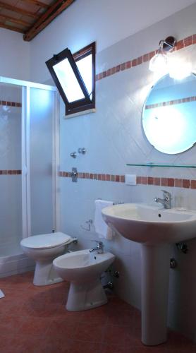 a bathroom with two sinks and a shower and a mirror at Palazzo Ossuna in Trapani