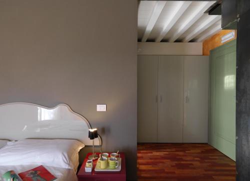 a bedroom with a bed and a table with a lamp at Camping Serenella in Bardolino