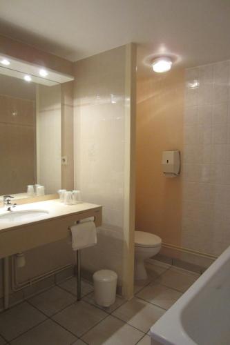 a bathroom with a sink and a toilet and a mirror at Hôtel SABLES D'O et son restaurant LE 16 BIS in Les Sables-dʼOlonne
