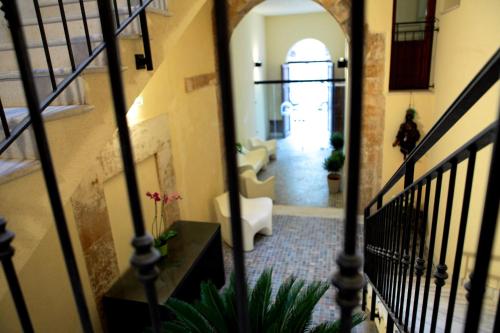 a hallway of a building with a stairway at Palazzo Ossuna in Trapani