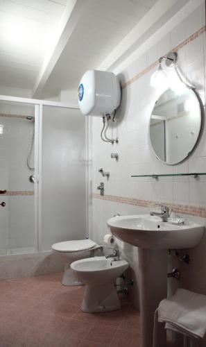 a bathroom with a sink and a shower and a toilet at Palazzo Ossuna in Trapani