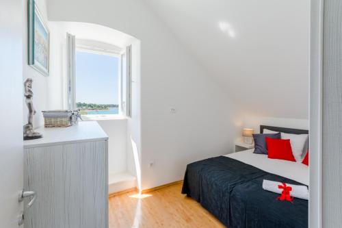 a bedroom with a bed and a window at Apartment Barbara in Supetar
