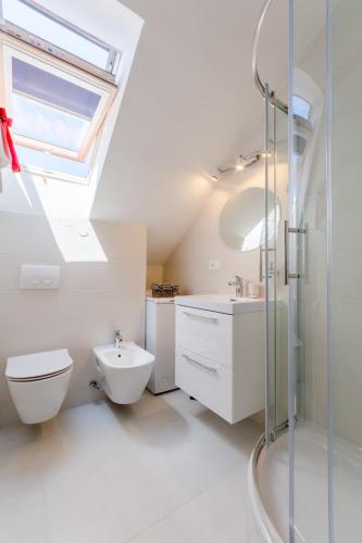 a bathroom with a sink toilet and a skylight at Apartment Barbara in Supetar