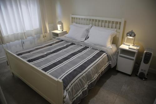 1 dormitorio con 1 cama grande y 2 mesitas de noche en Apartamento central, novo e com garagem em Curitiba, en Curitiba
