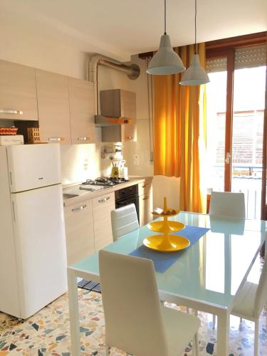 a kitchen with a blue table and white appliances at Vittoria Colonna in Vittoria