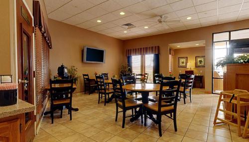 a dining room with tables and chairs in a restaurant at Americas Best Value Inn St. Louis / South in Saint Louis