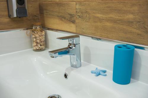 a sink with a faucet in a bathroom at Apartments Villa Monique in Rogoznica